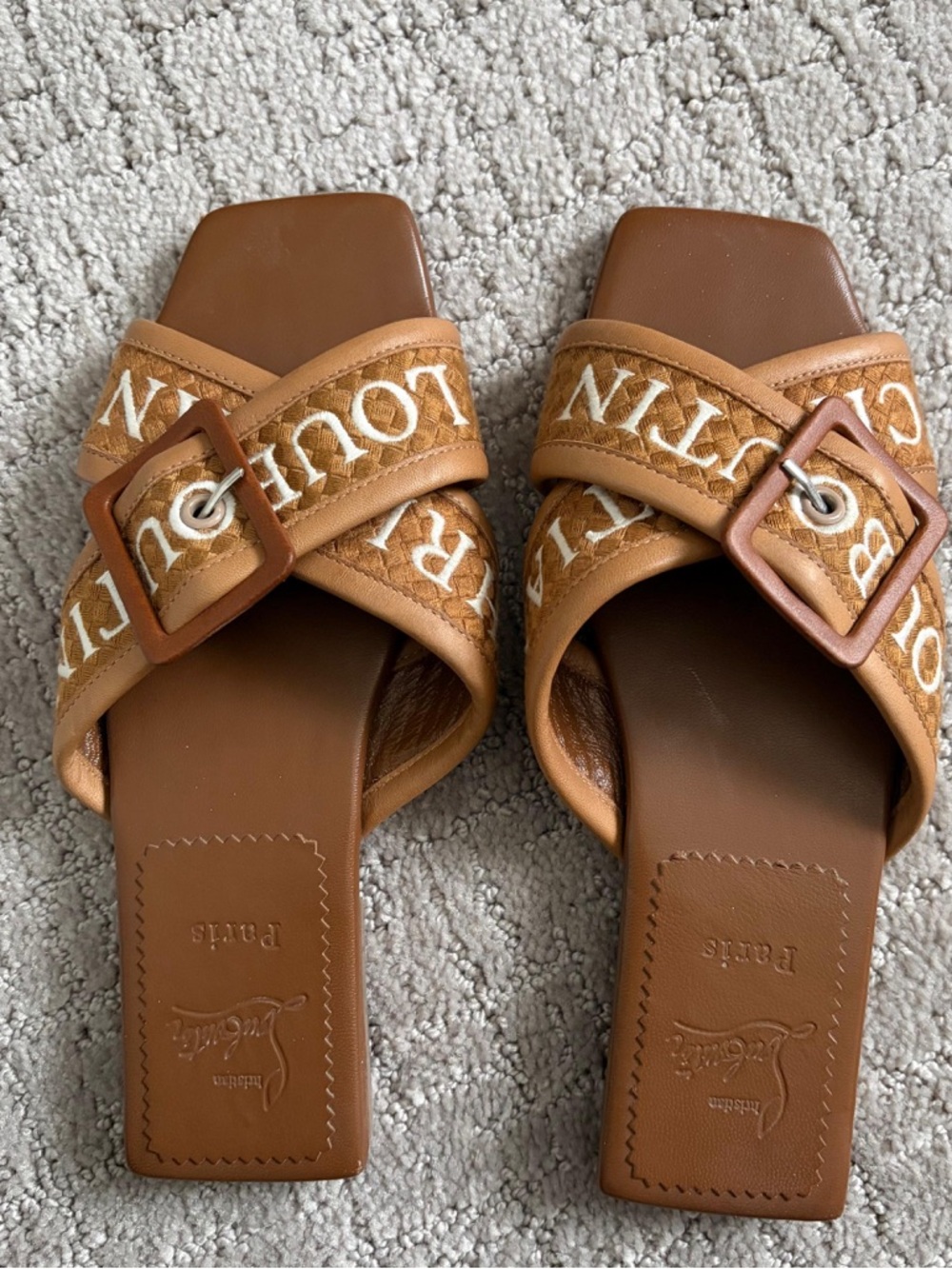 Christian Louboutin Crossimule leather slides in a tan brown woven design.